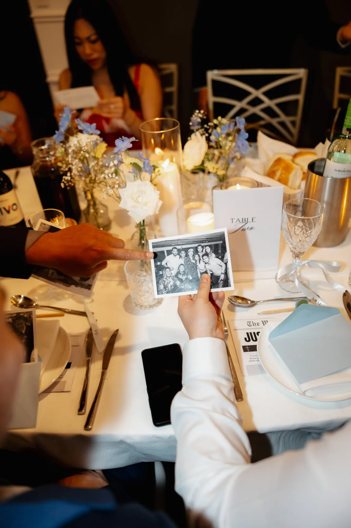 Guest table with candles and florals during the reception