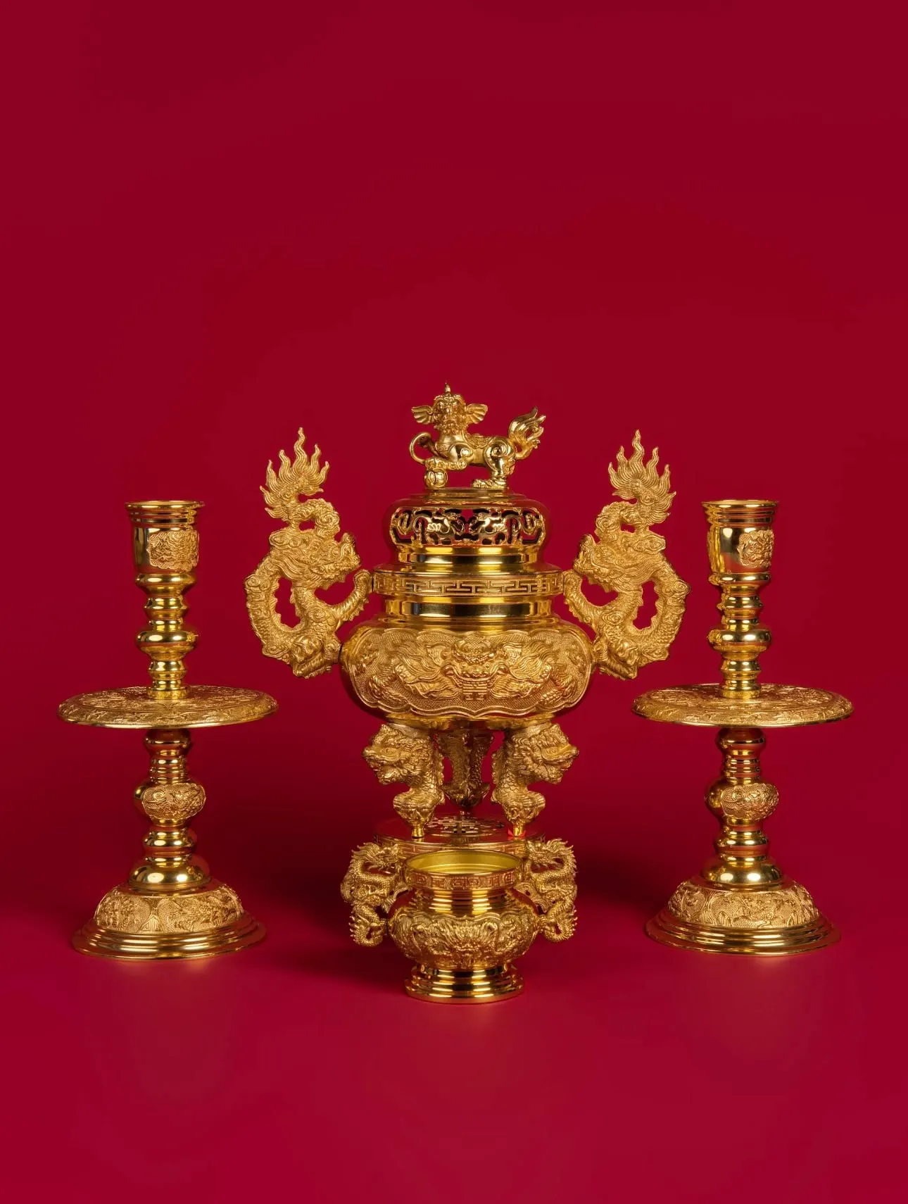 Gold altar set with an incense burner and a pair of candlesticks