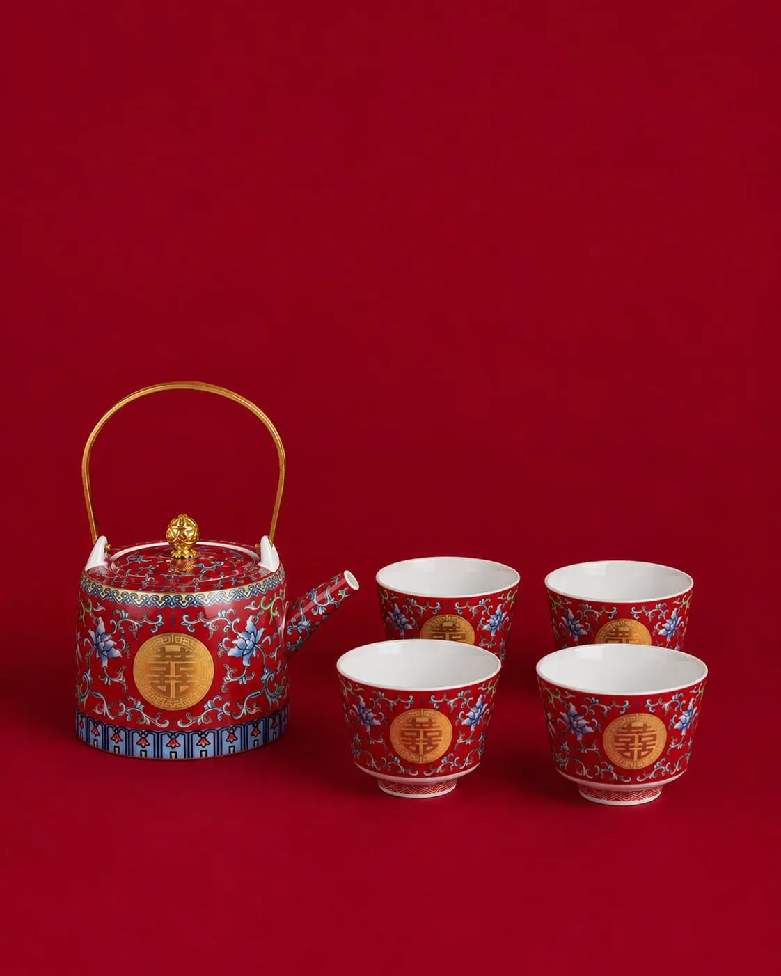 Red and blue porcelain teapot with four matching tea cups