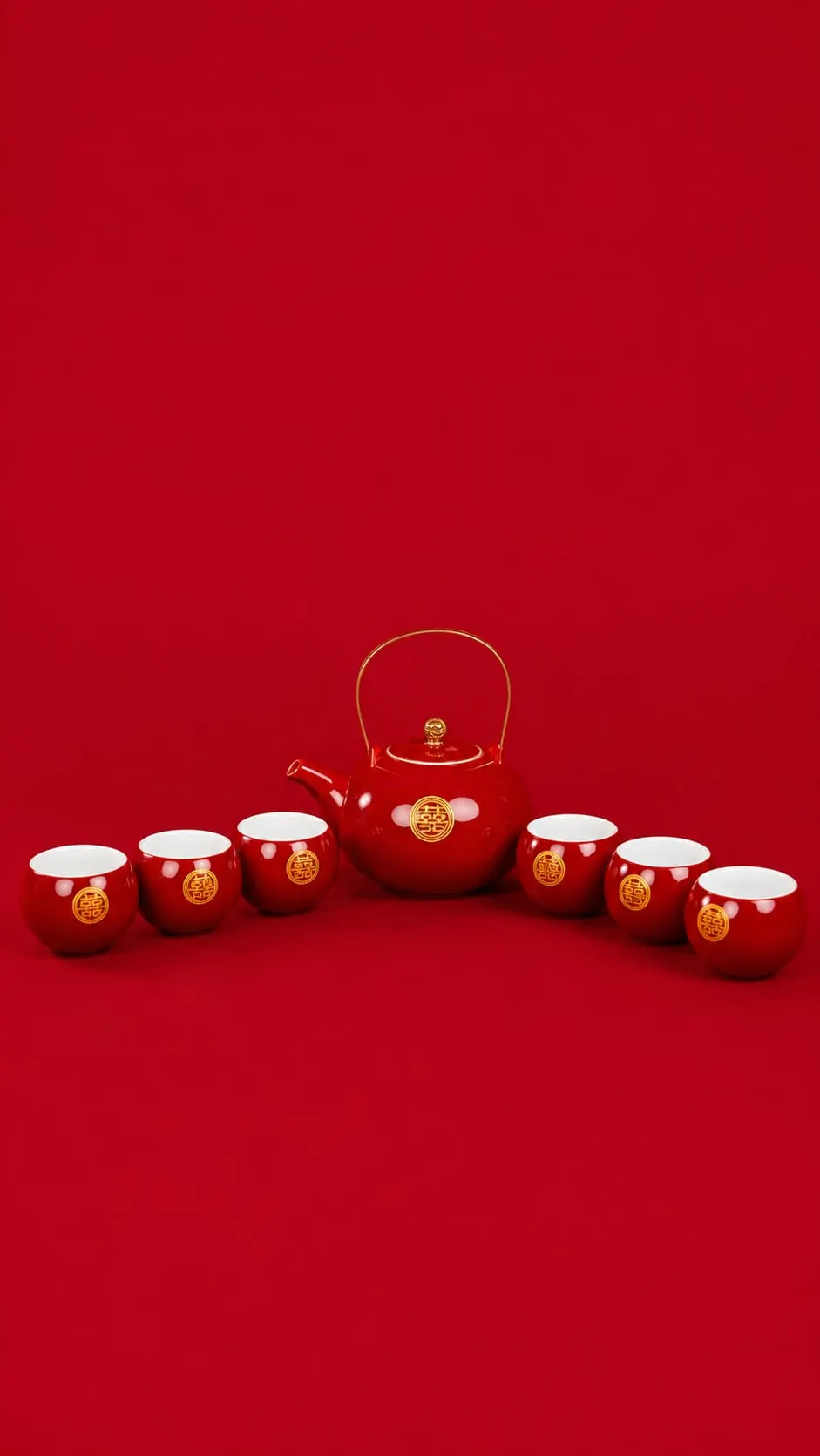 Red porcelain tea set with teapot and six cups