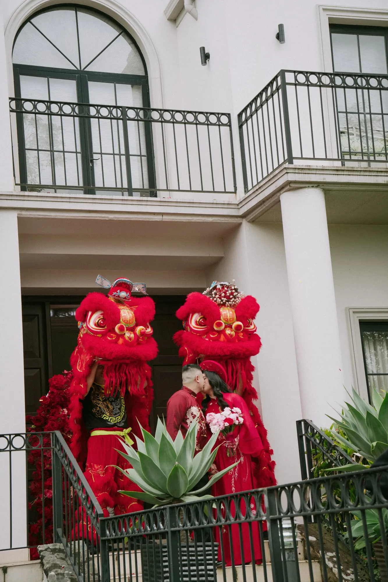 Lion dancers at the front gate of the family home